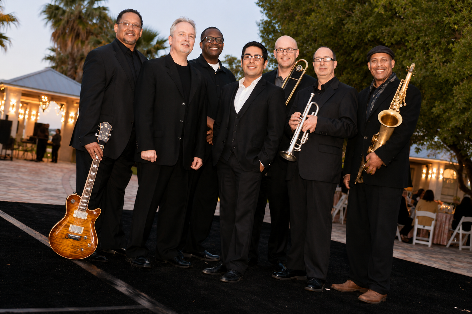 Live band in formal attire at elegant outdoor wedding venue