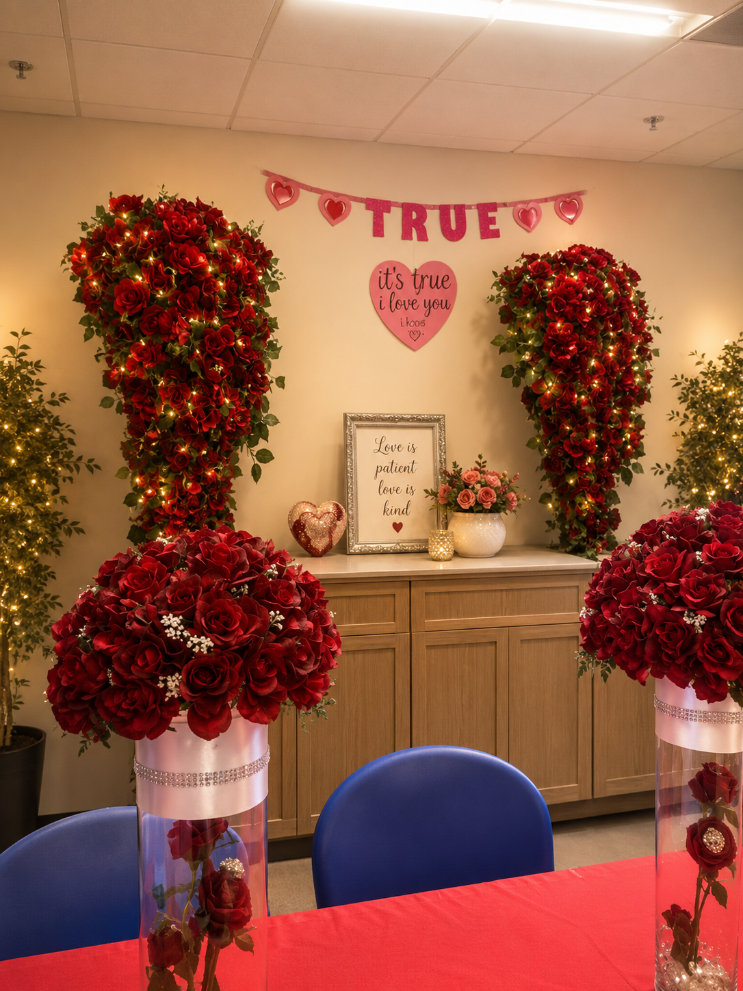 Valentine's Day event close-up with red rose heart installations, fairy lights and love-themed signage